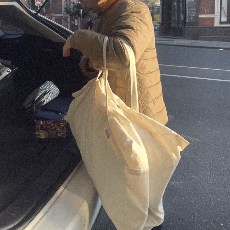 A man lifting a Litual bag into the boot of a car