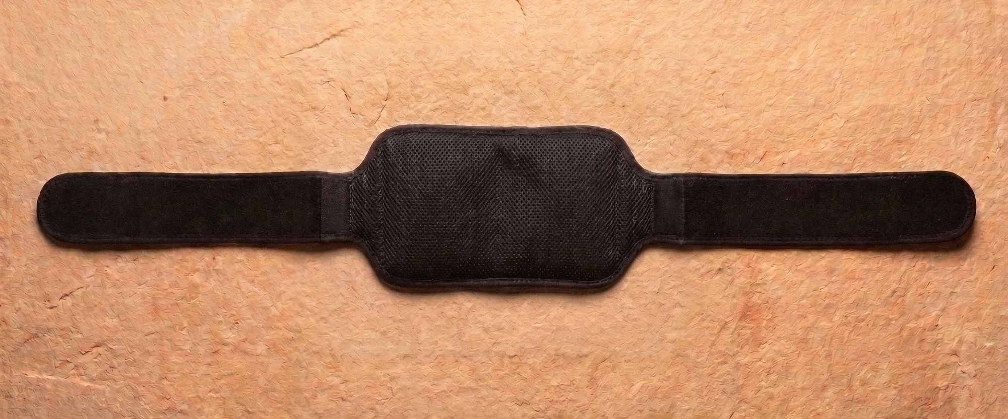 Poom laid flat on sandstone, the full length of the band visible