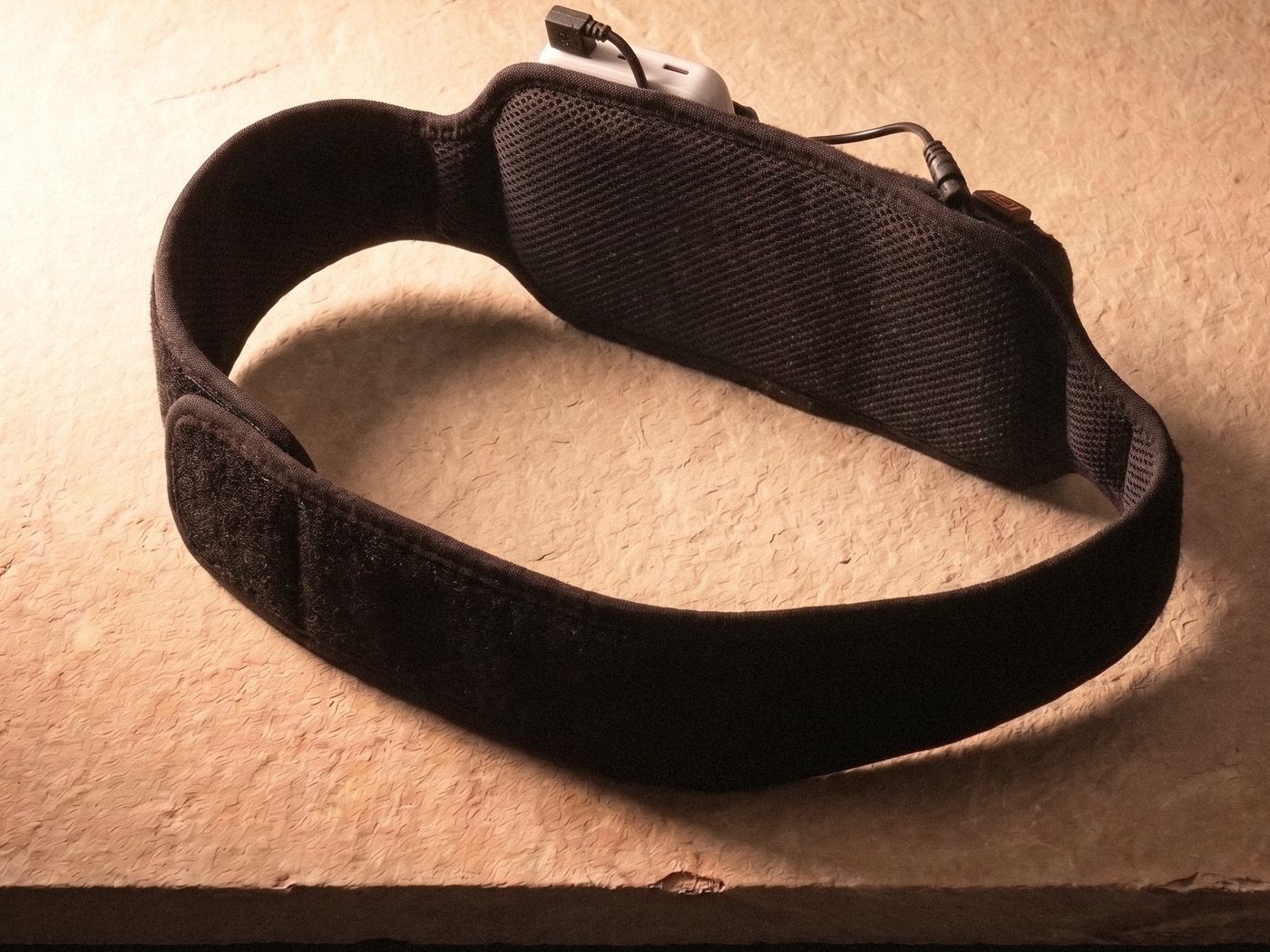 Poom standing on its edge on sandstone, showing the breathable mesh lining on the inside